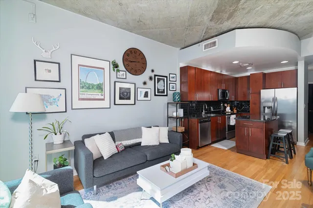 a living room with furniture and kitchen view