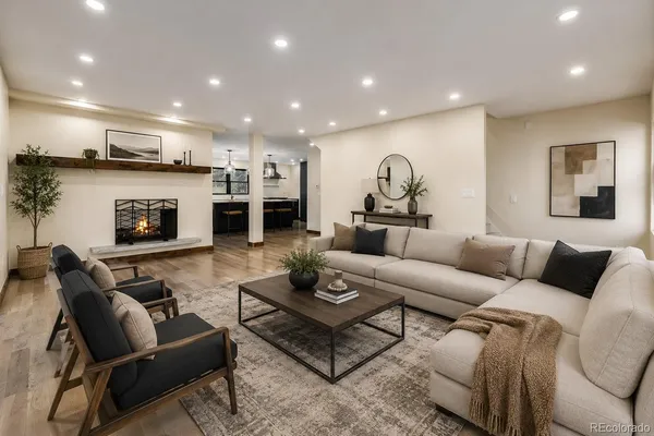 a living room with furniture and a fireplace