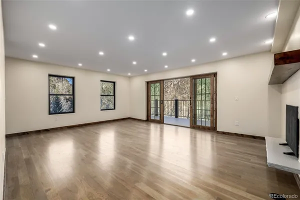 a view of kitchen and hall with furniture wooden floor