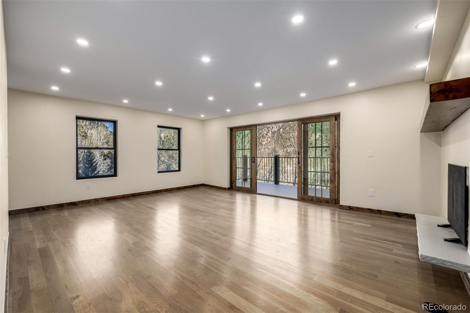 205 Loop Drive Georgetown, CO 80444 - Photo 14 of 49 a view of an empty room with wooden floor and a window