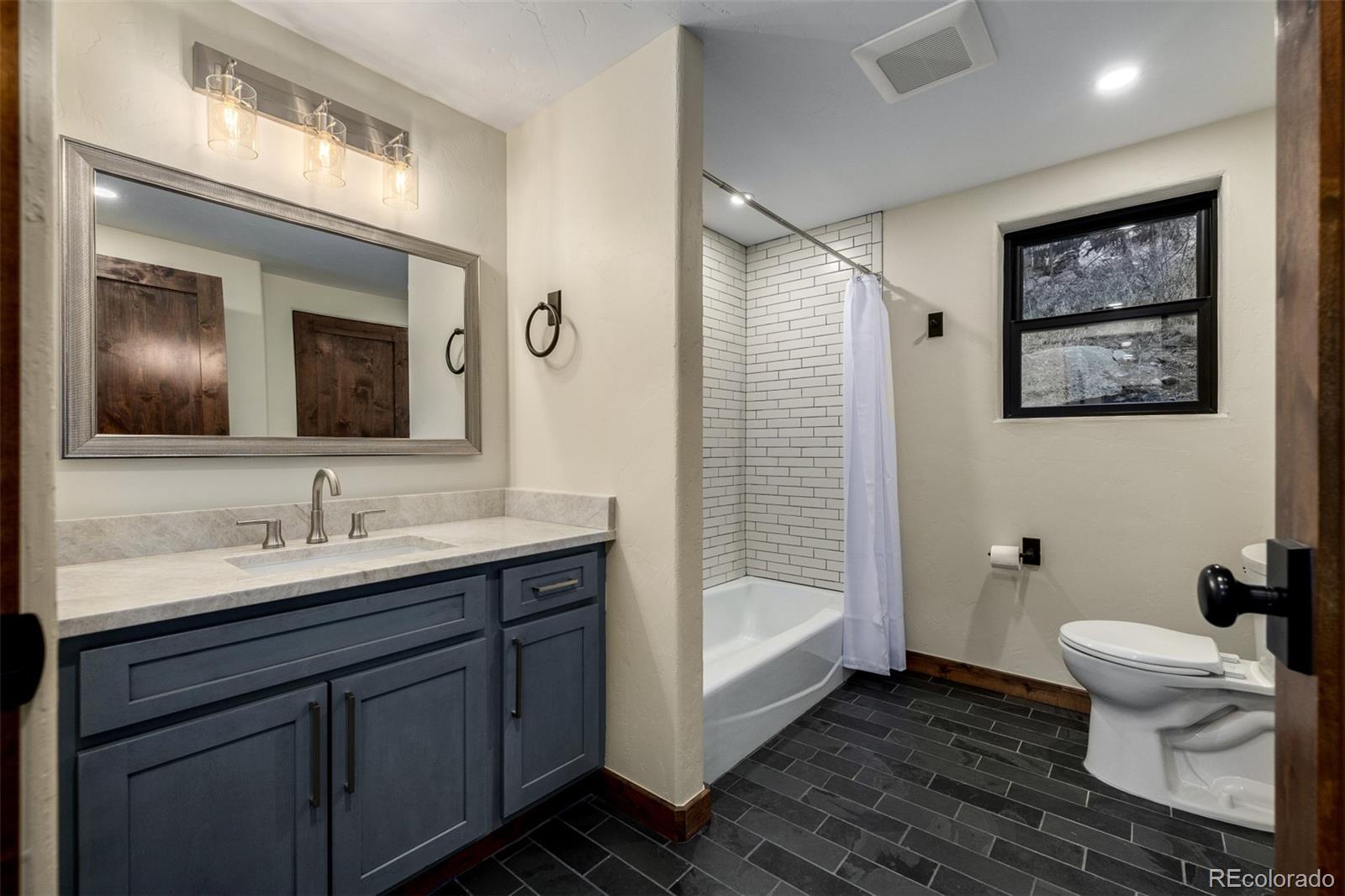 205 Loop Drive Georgetown, CO 80444 - Photo 31 of 49 a bathroom with a toilet sink and mirror