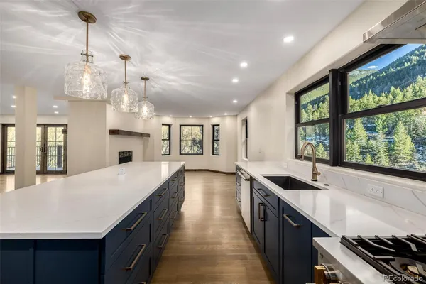 a kitchen with granite countertop a stove and a sink