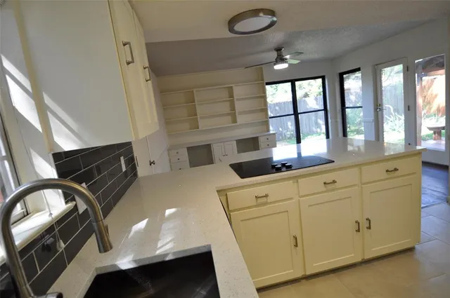 a kitchen with stainless steel appliances a stove a sink and a refrigerator