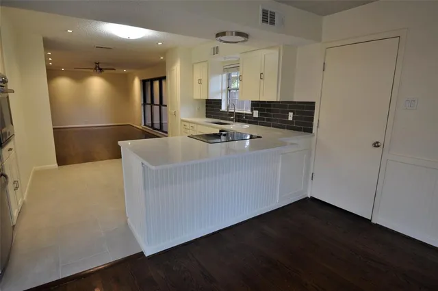 a view of kitchen with stainless steel appliances a sink dishwasher a refrigerator and wooden floor