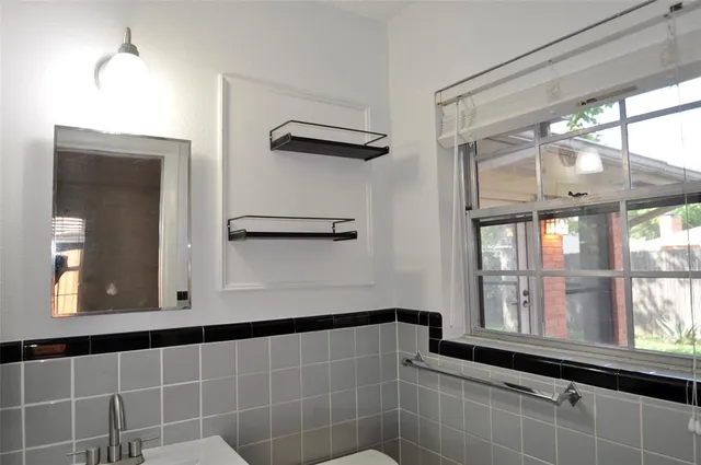 a bathroom with a large window and a shower