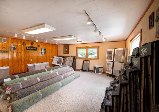 a bedroom with furniture ceiling fan and a window