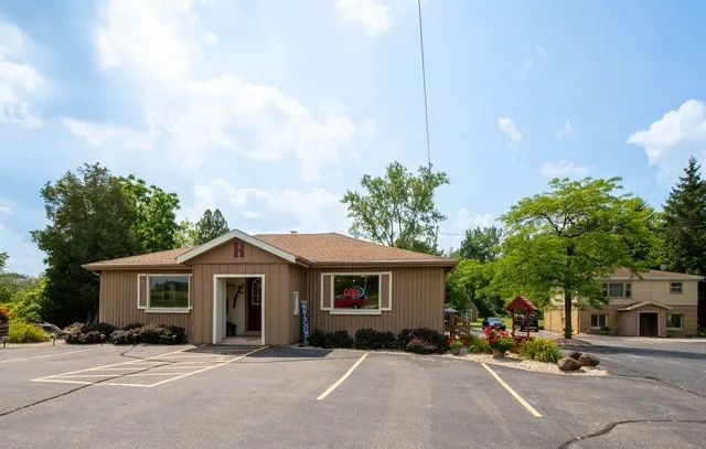 a front view of a house with a yard and a garage