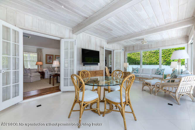 229 Pendleton Avenue Palm Beach, FL 33480 - Photo 12 of 36 a dining room with furniture and a flat screen tv
