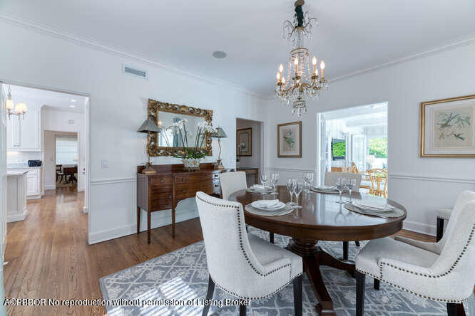 229 Pendleton Avenue Palm Beach, FL 33480 - Photo 15 of 36 a view of a dining room with furniture wooden floor and chandelier