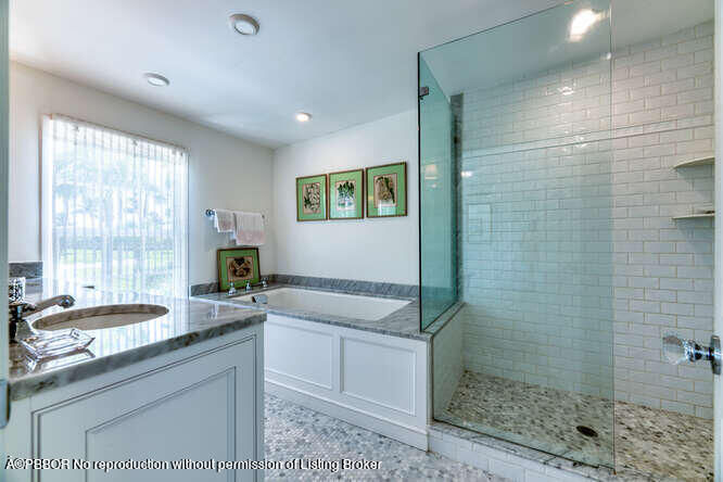 229 Pendleton Avenue Palm Beach, FL 33480 - Photo 25 of 36 a bathroom with a granite countertop sink a toilet a mirror and shower