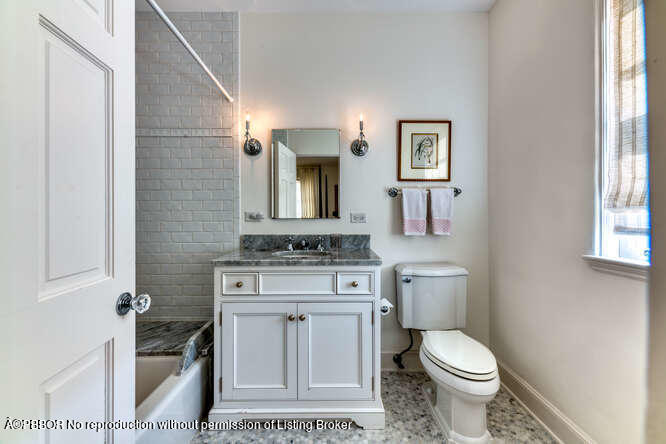 229 Pendleton Avenue Palm Beach, FL 33480 - Photo 32 of 36 a bathroom with a toilet a sink and mirror