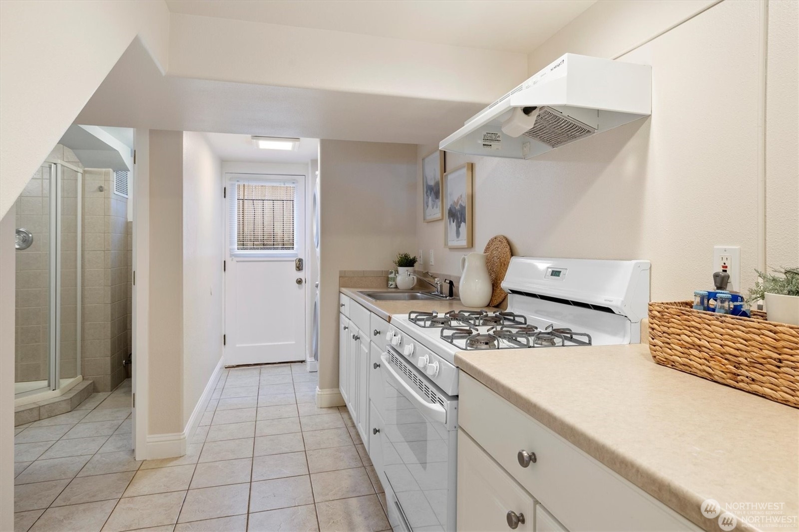 3801 Northeast 75th Street Seattle, WA 98115 - Photo 25 of 40 a kitchen with a stove and white cabinets
