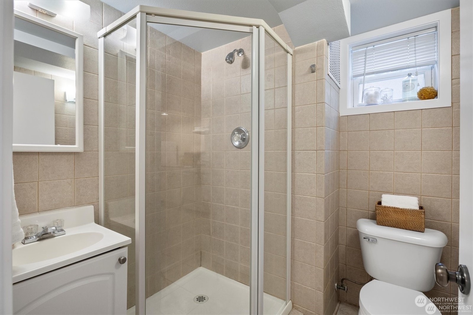 3801 Northeast 75th Street Seattle, WA 98115 - Photo 27 of 40 a bathroom with a toilet sink vanity and shower