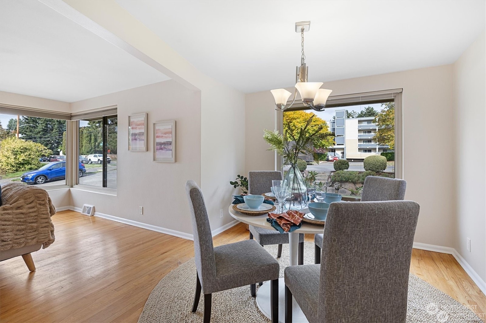 3801 Northeast 75th Street Seattle, WA 98115 - Photo 8 of 40 a dining room with furniture a potted plant and a chandelier