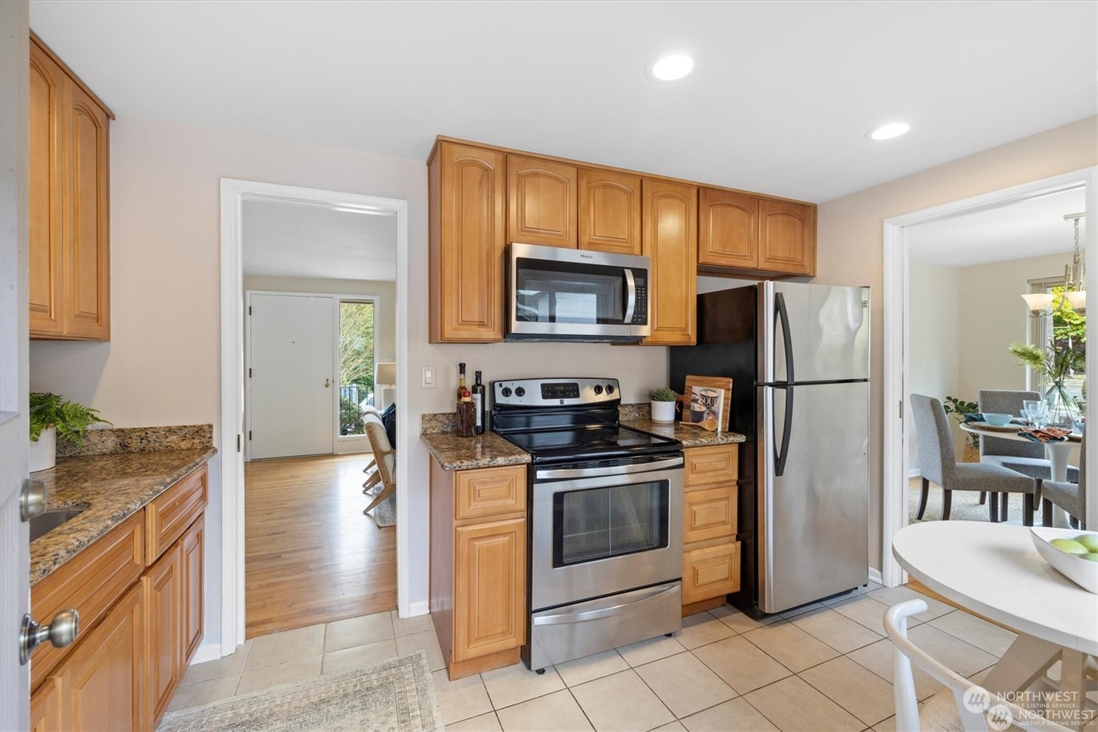 3801 Northeast 75th Street Seattle, WA 98115 - Photo 10 of 40 a kitchen with stainless steel appliances granite countertop a refrigerator stove and microwave
