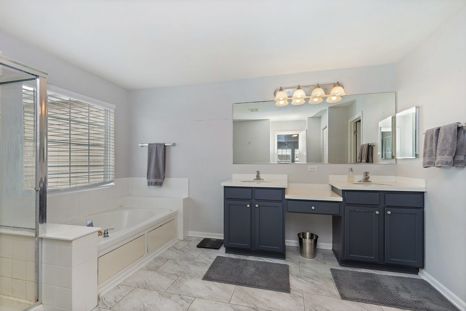 32205 Rockwell Drive McHenry, IL 60051 - Photo 20 of 27 a spacious bathroom with a tub sink and mirror