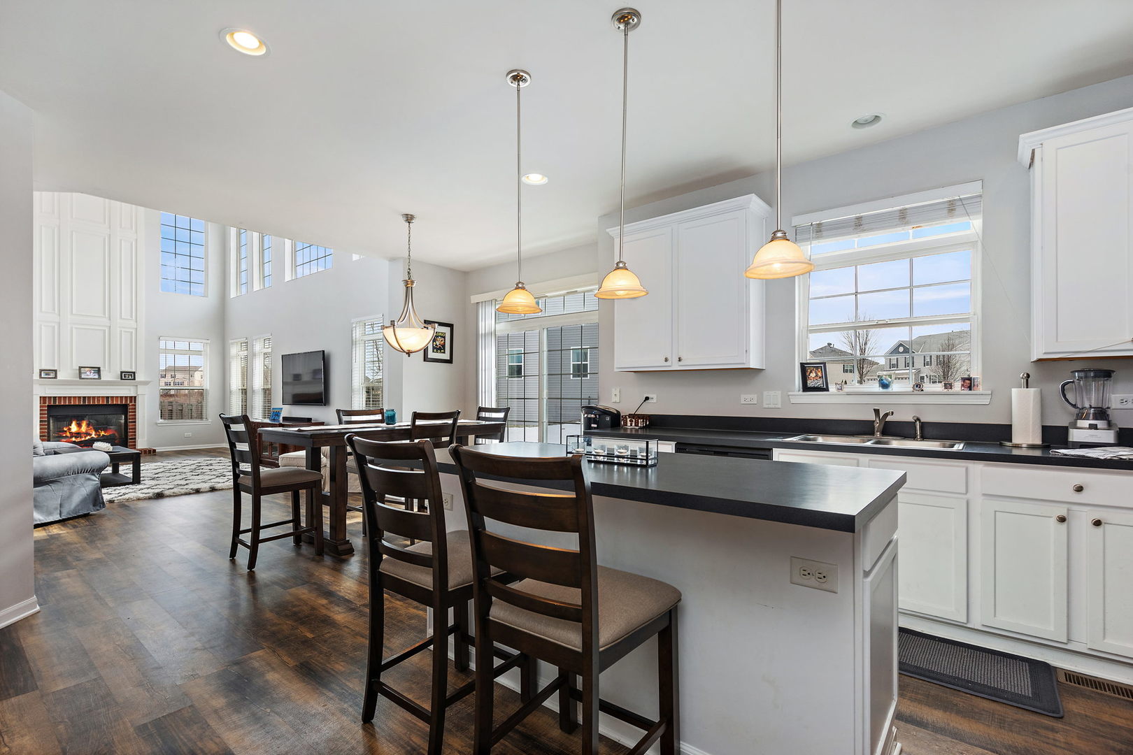 32205 Rockwell Drive McHenry, IL 60051 - Photo 8 of 27 a kitchen with stainless steel appliances granite countertop a stove a sink a island a dining table and chairs with wooden floor