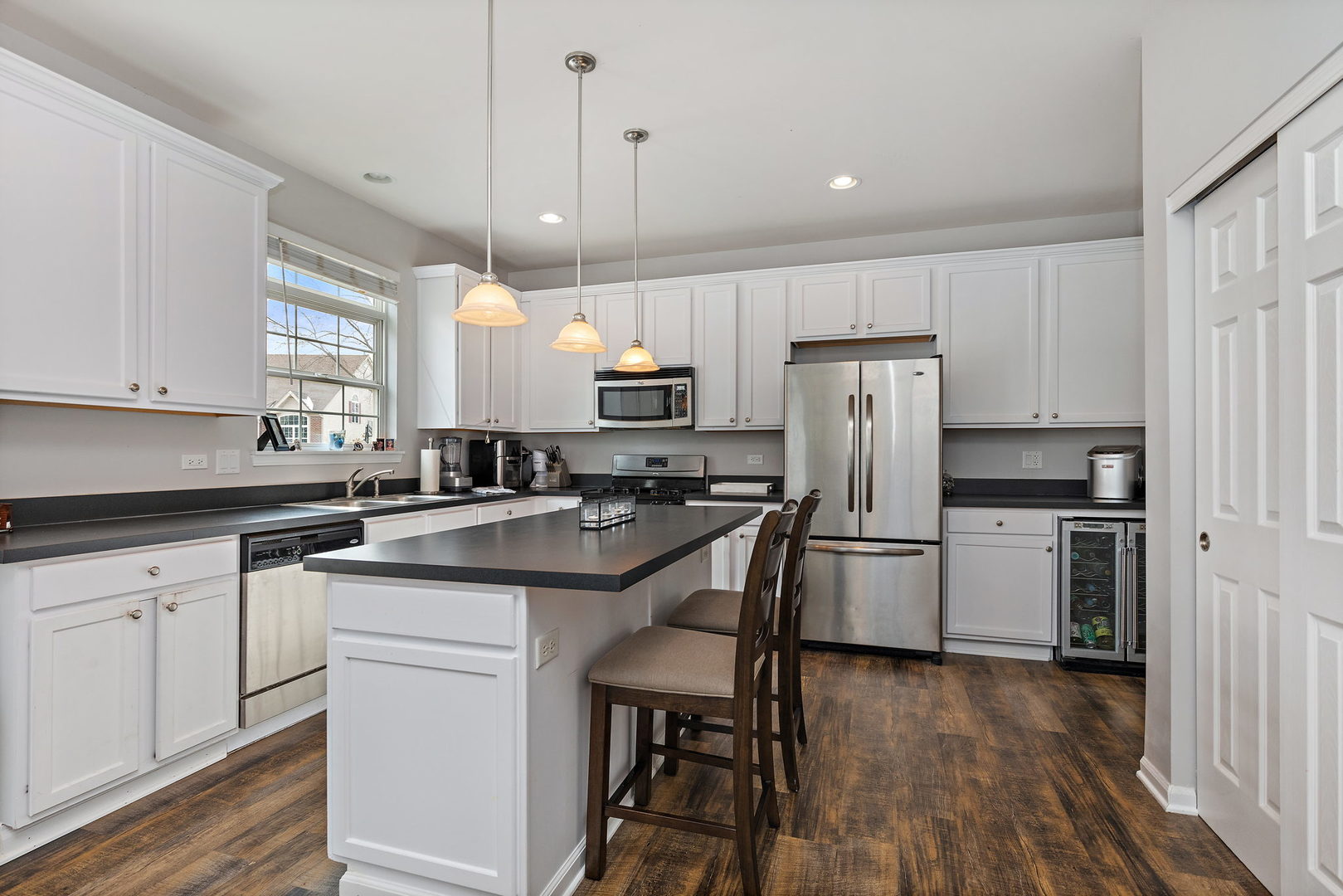 32205 Rockwell Drive McHenry, IL 60051 - Photo 10 of 27 a kitchen with a sink a center island stainless steel appliances and cabinets