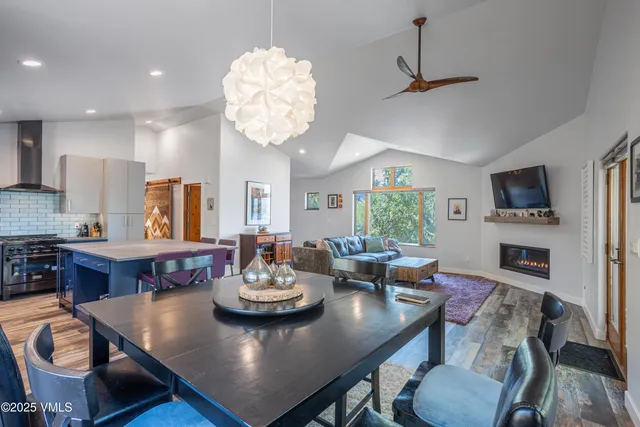 a view of a dining room with furniture a chandelier and wooden floor