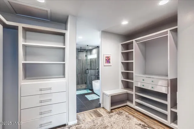 a white bath tub sitting next to a bathroom