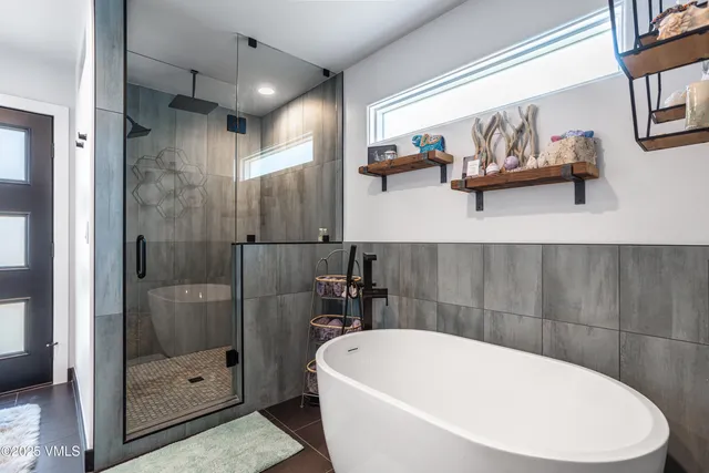 a living room with furniture and a view of kitchen