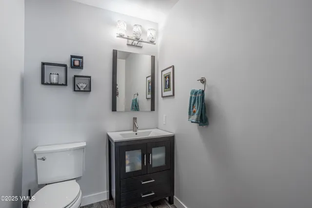 a bedroom with a large bed and windows