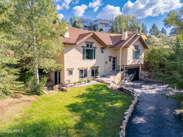a aerial view of a house with swimming pool and sitting area