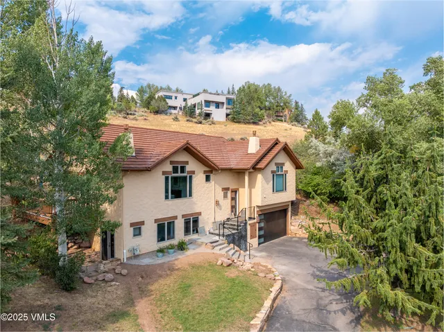 a backyard of a house with yard and outdoor seating