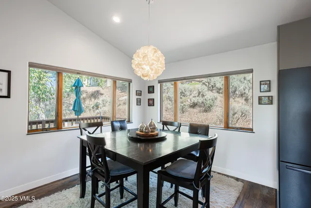 a large kitchen with lots of counter space a sink and chairs