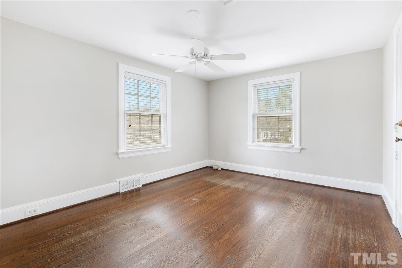 2115 Reaves Drive Raleigh, NC 27608 - Photo 21 of 26 an empty room with wooden floor and windows