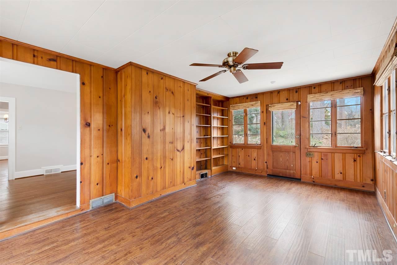 2115 Reaves Drive Raleigh, NC 27608 - Photo 7 of 26 a view of an empty room with a window and wooden floor