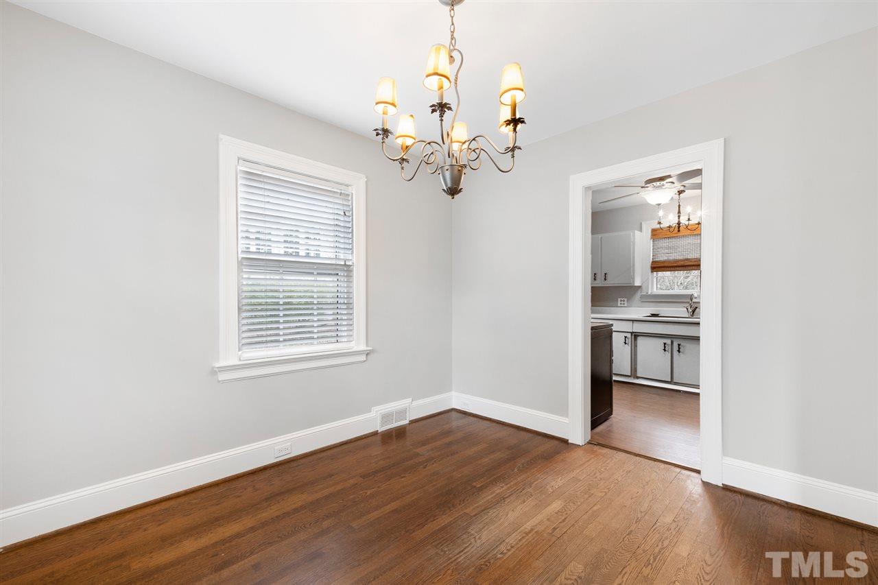 2115 Reaves Drive Raleigh, NC 27608 - Photo 10 of 26 a view of a kitchen with wooden floor and a window