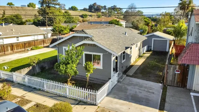 a house view with a garden and deck