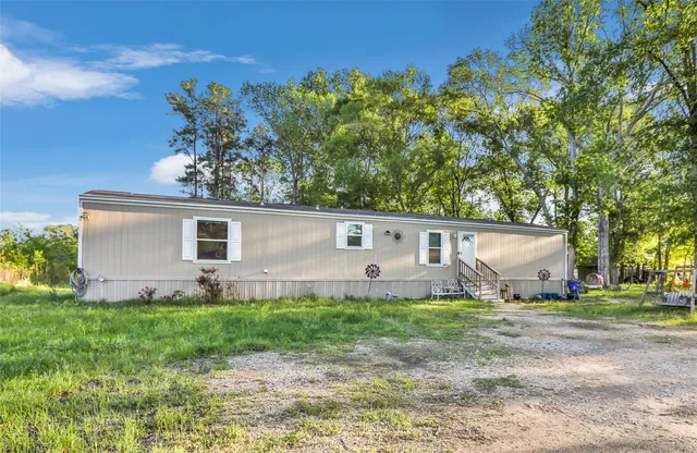 a house that has a tree in front of it