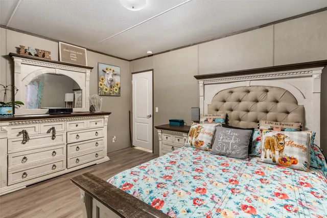 a bedroom with a bed and a dresser in it