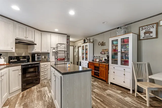 a kitchen with stainless steel appliances granite countertop a stove and a refrigerator