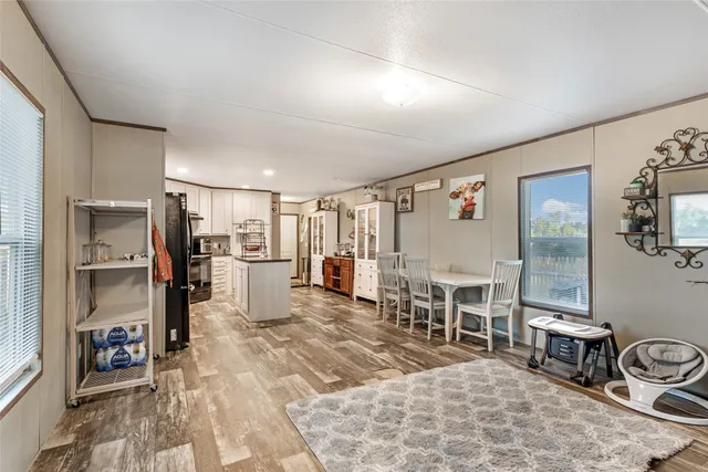 a living room with furniture a flat screen tv and chairs
