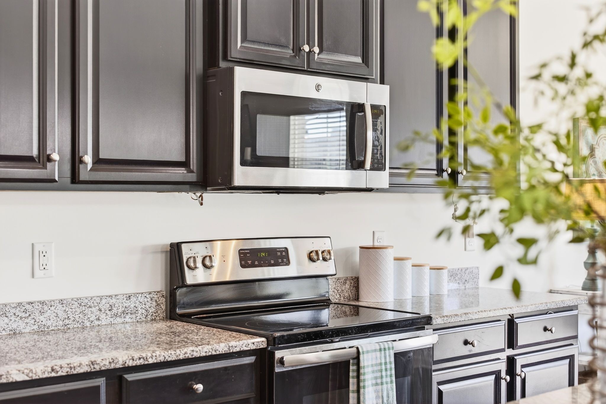 423 Heroit Drive Spring Hill, TN 37174 - Photo 17 of 43 a kitchen with stainless steel appliances granite countertop a stove and a microwave