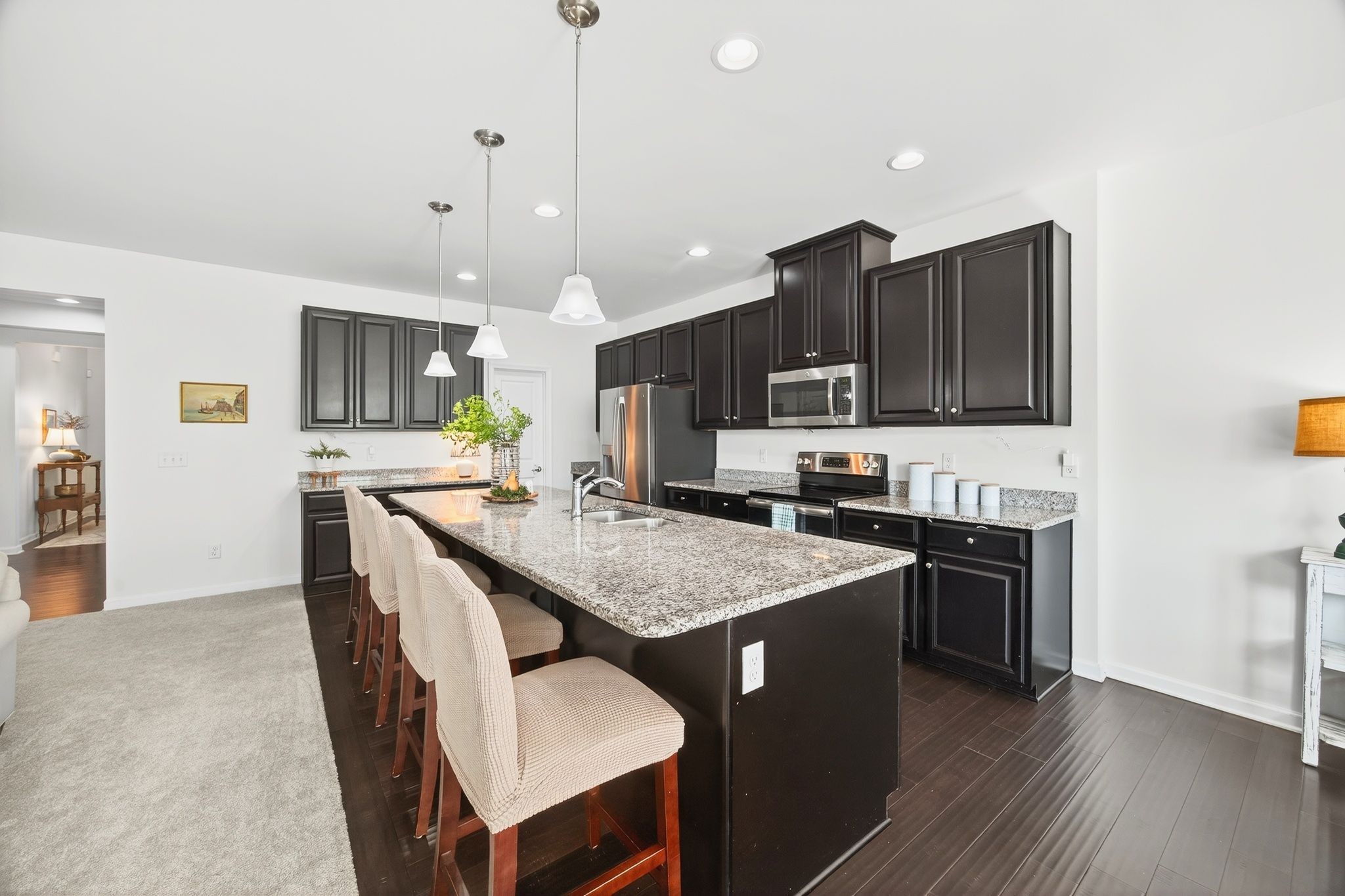423 Heroit Drive Spring Hill, TN 37174 - Photo 20 of 43 a kitchen with stainless steel appliances granite countertop a stove top oven a sink dishwasher and a refrigerator with wooden floor