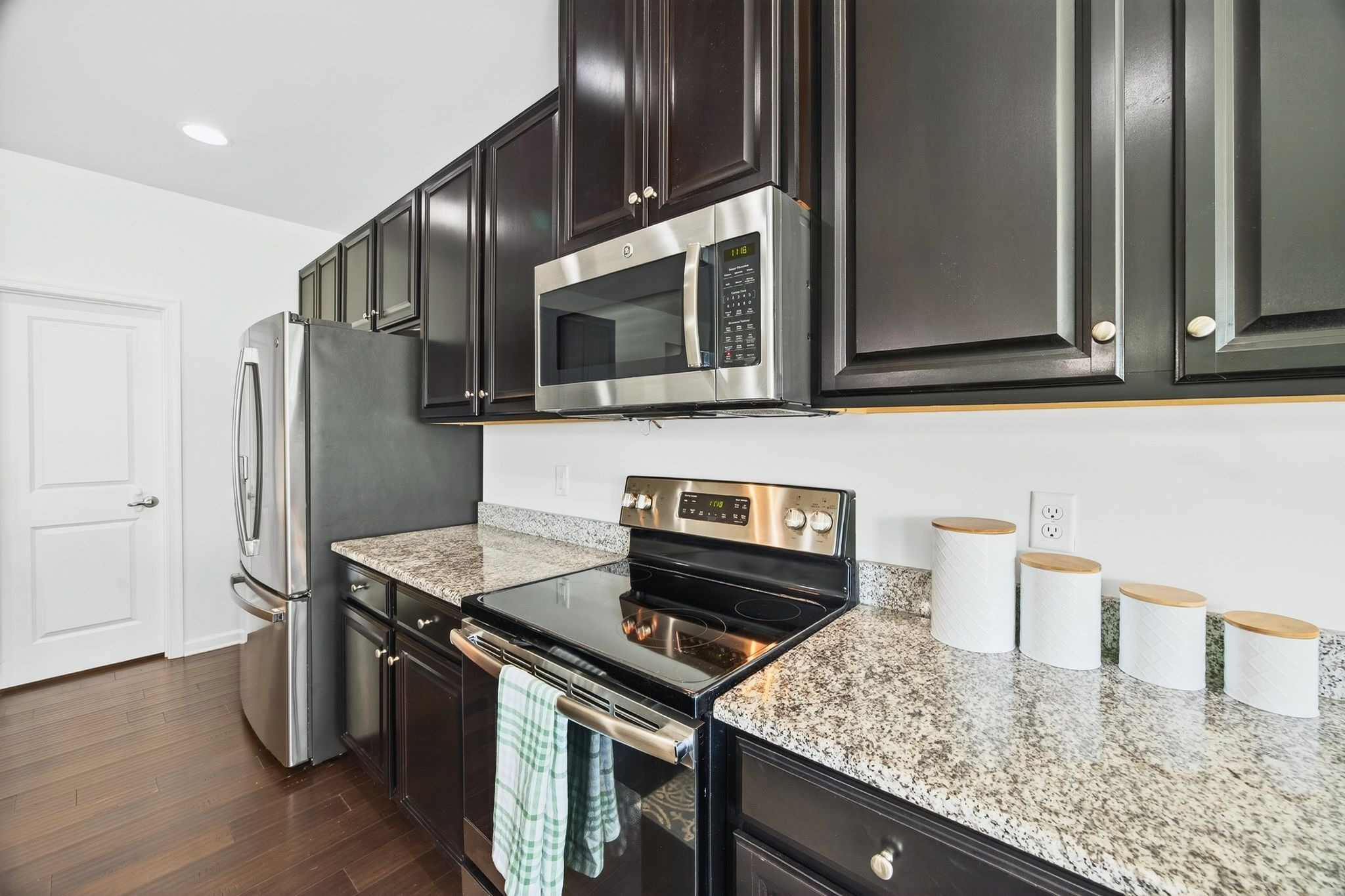 423 Heroit Drive Spring Hill, TN 37174 - Photo 21 of 43 a kitchen with stainless steel appliances granite countertop a refrigerator and a stove