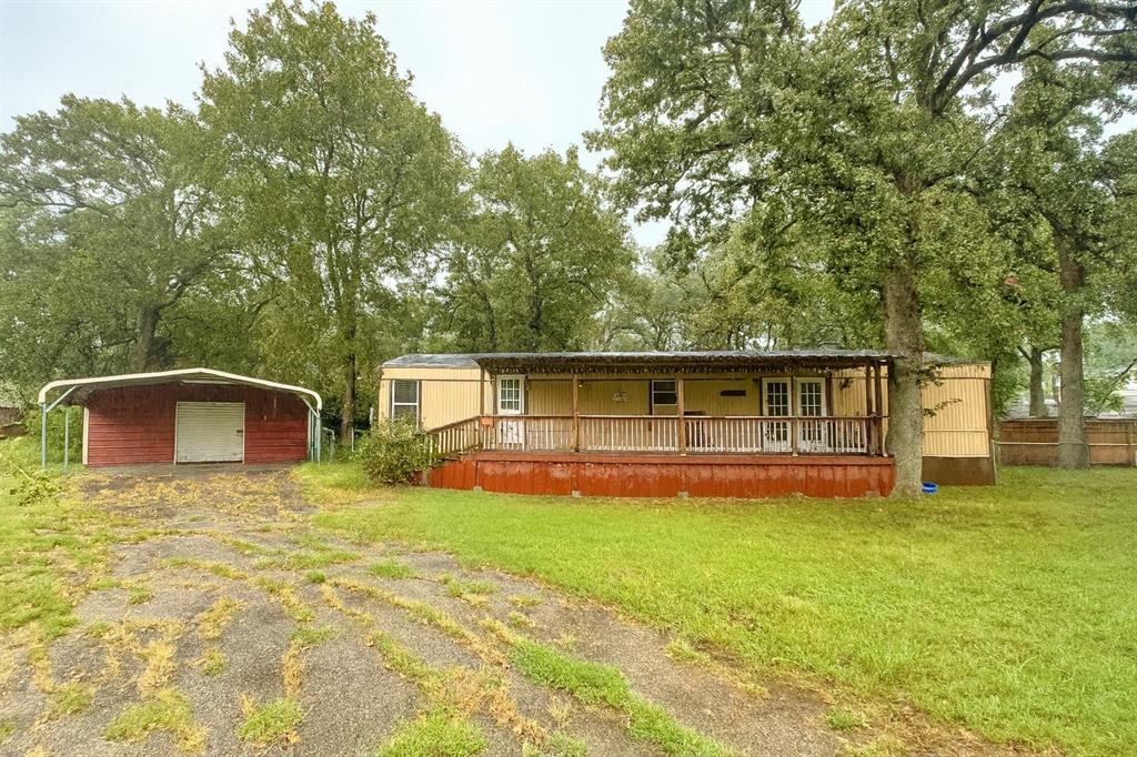 9949 Green Tree Lane Wills Point, TX 75169 - Photo 1 of 9 a front view of house with yard and trees in the background