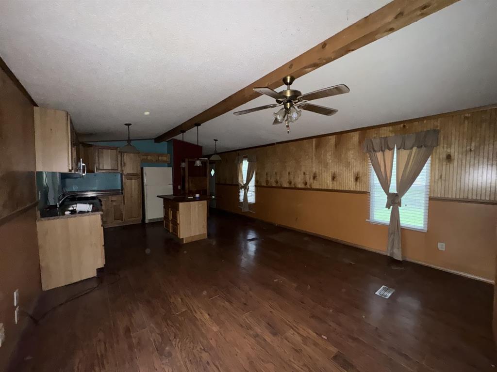 9949 Green Tree Lane Wills Point, TX 75169 - Photo 2 of 9 a kitchen with stainless steel appliances a refrigerator a sink a stove and microwave with wooden floor
