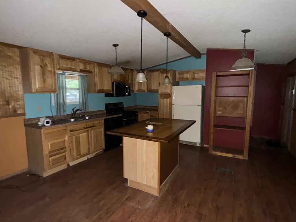 9949 Green Tree Lane Wills Point, TX 75169 - Photo 3 of 9 a kitchen with a sink a counter space and wooden floor