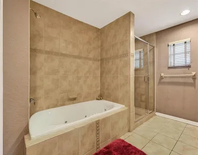 a bathroom with a bathtub and shower