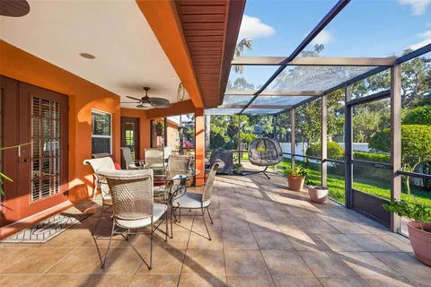 a view of a patio with table and chairs next to a yard