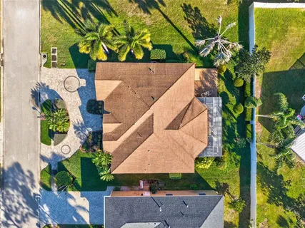 an aerial view of a house with a yard