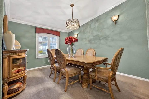 a view of a dining room with furniture and a chandelier