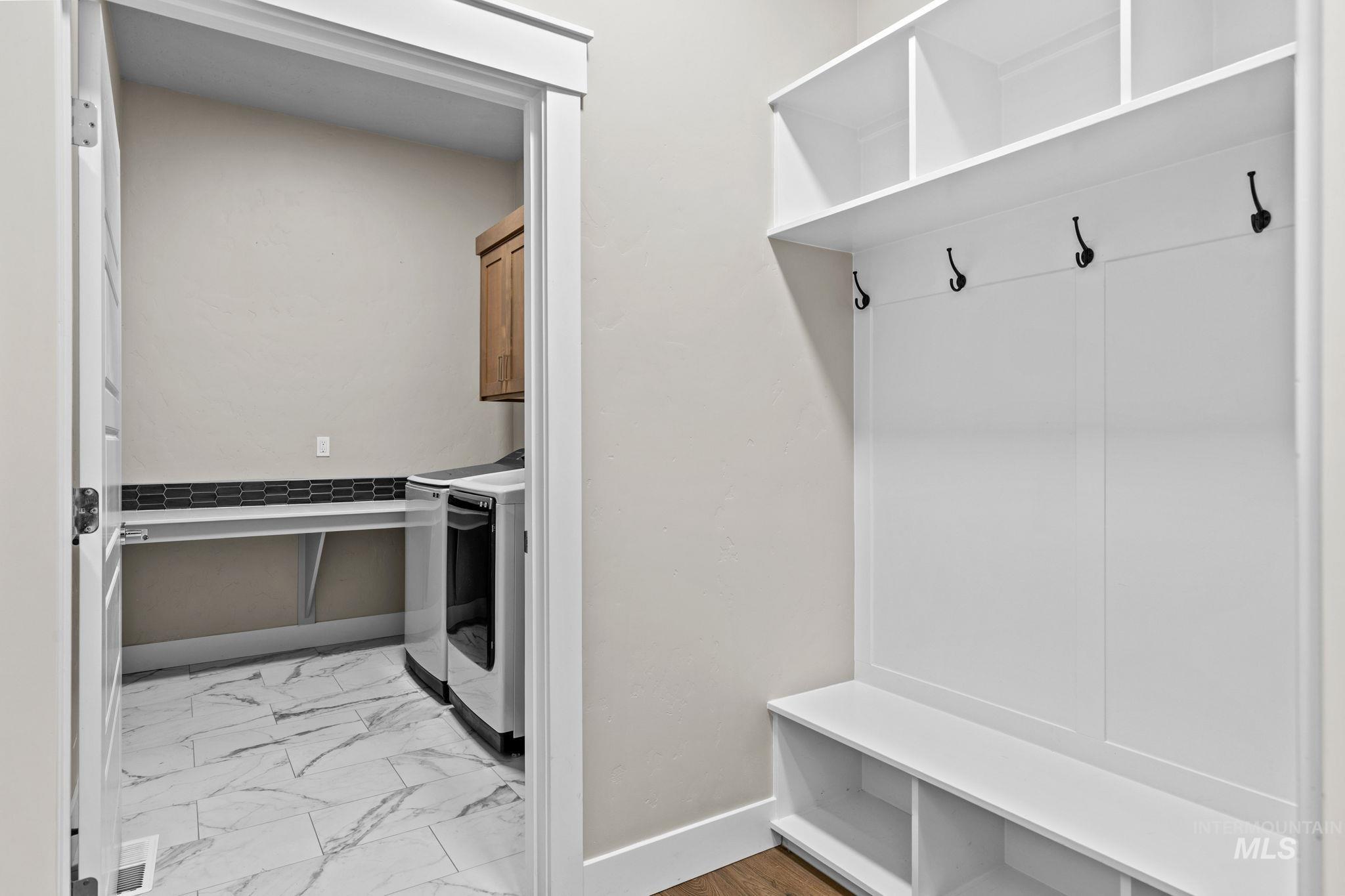 2934 East Murchison Street Meridian, ID 83642 - Photo 19 of 44 Built-in white storage unit featuring shelving, coat hooks, and bench seating