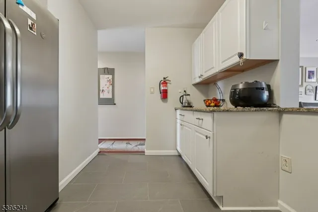 a kitchen with white cabinets and white appliances