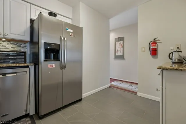 a kitchen with metallic refrigerator freezer and a dishwasher